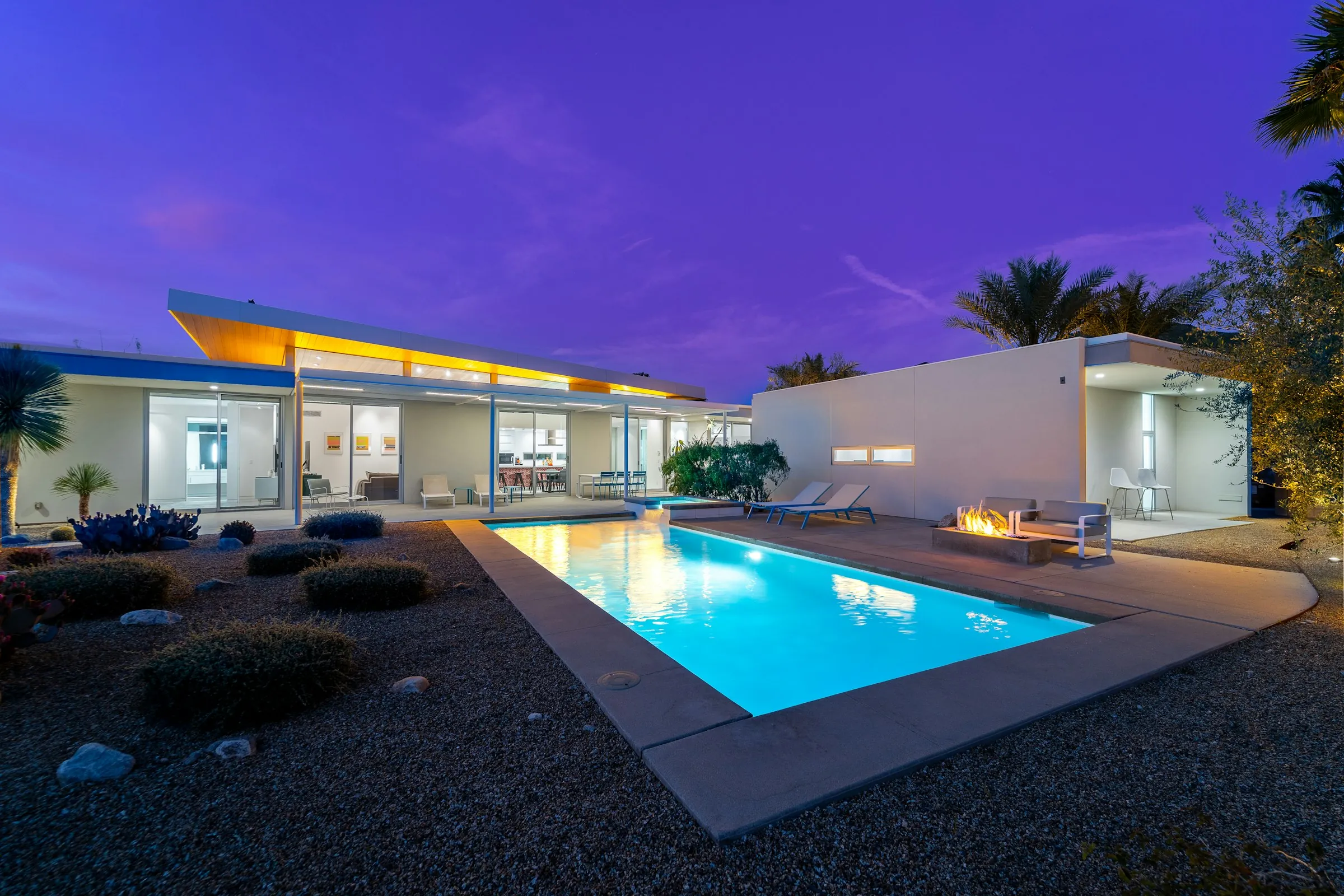 Residence with an illuminated pool at dusk